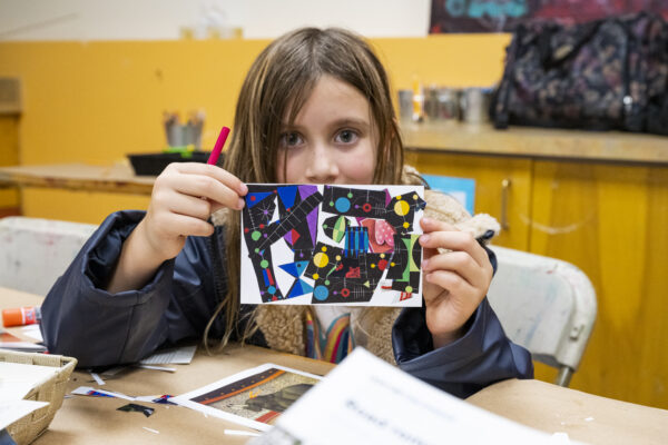 Child holding up art they made